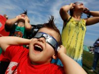 Damien Hoeffler, 3, is wowed as he along with his brother, William Hoeffler, 6, left, and mother, Autumn Hoeffler, take a look at the eclipse in front of the UMass Dartmouth observatory.   [ PETER PEREIRA/THE STANDARD-TIMES/SCMG ]